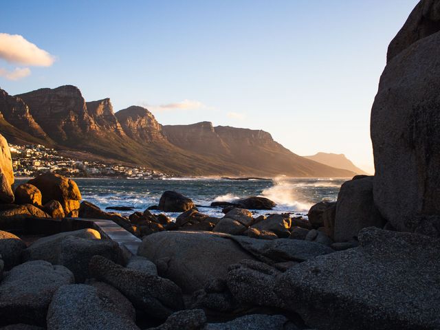 Golden light on the granite boulders at Camps Bay, with the Twelve Apostles behind