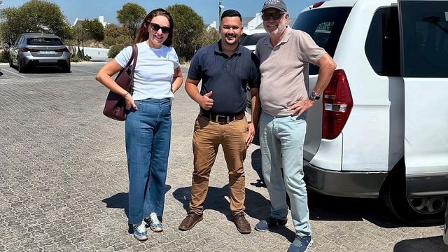 Happy guests beside the white van